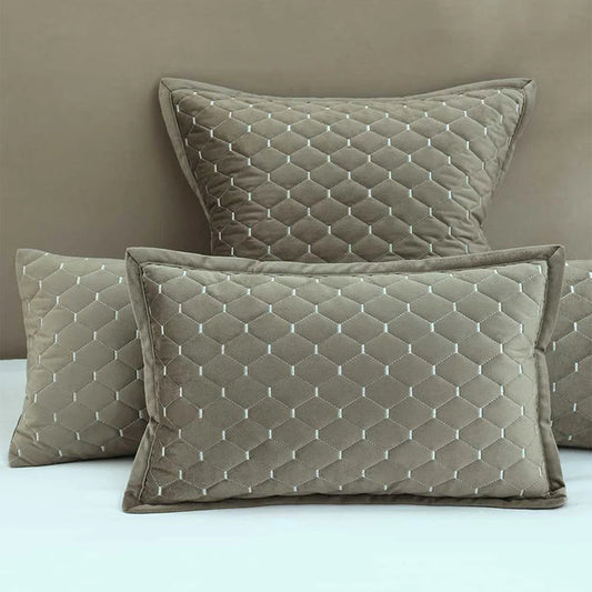 Turner Oak Pillows and Cushions  on a bed against a beige wall