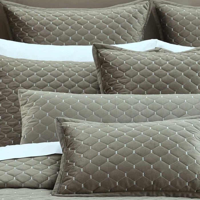 Turner Oak Pillows and Cushions  on a bed with a neutral background