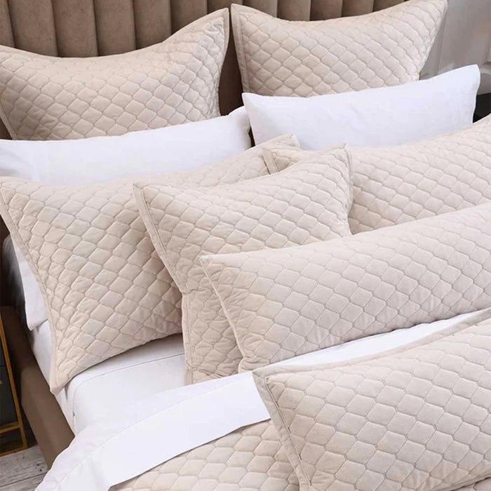 Turner Latte Pillows and Cushions on a bed with white bedding
