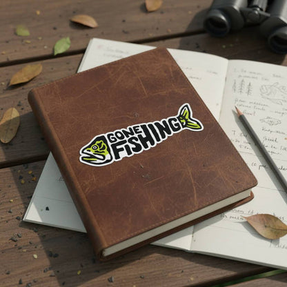 Forager Provisions LTD Gone Fishing vinyl sticker featuring a green fish graphic on a brown leather journal.