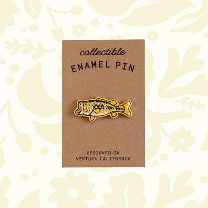 Forager Provisions LTD metallic gold largemouth bass enamel pin on a kraft cardstock backing.