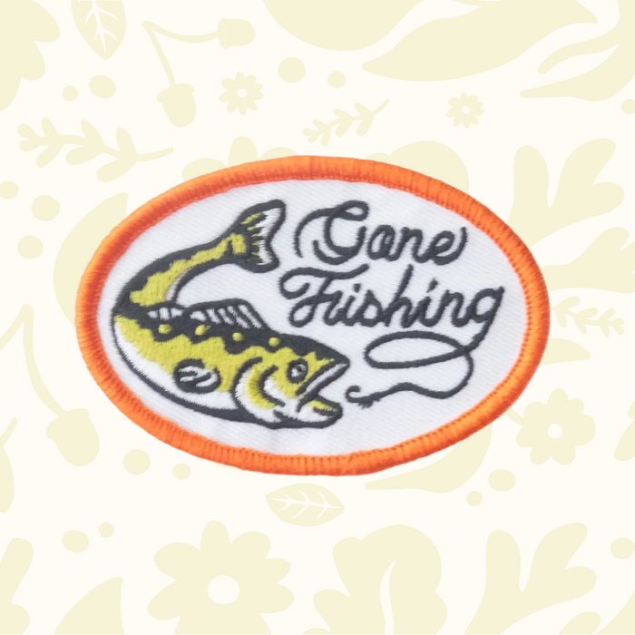 Forager Provisions LTD oval embroidered iron-on patch featuring a yellow fish and Gone Fishing text on white fabric.