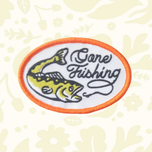 Forager Provisions LTD oval embroidered iron-on patch featuring a yellow fish and Gone Fishing text on white fabric.