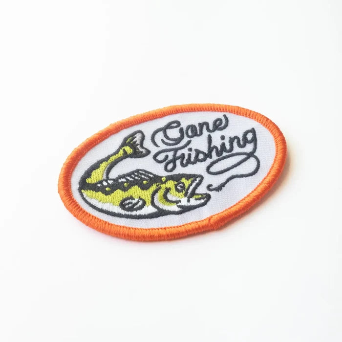 Union Made Oval Embroidered Iron On Patch, Gone Fishing design with fish, orange border, bold text on white. Perfect for jackets.