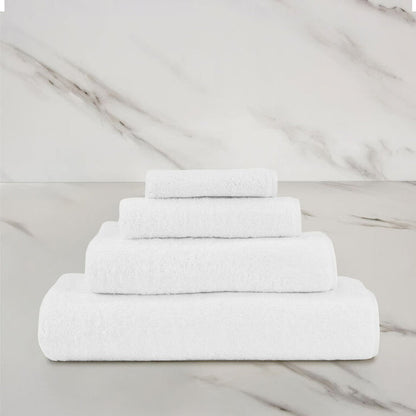 a white unito hand towel stacked on unito towels on a marbeled surface and background