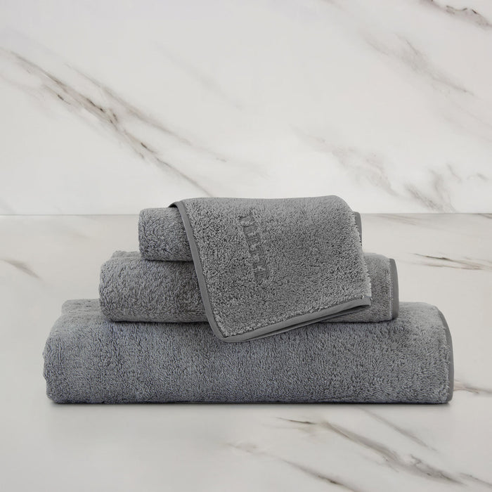 Unito Slate Grey Wash Cloth on a marble surface