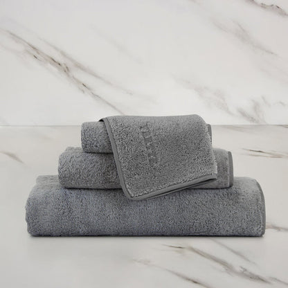 Unito Slate Grey Wash Cloth on a marble surface