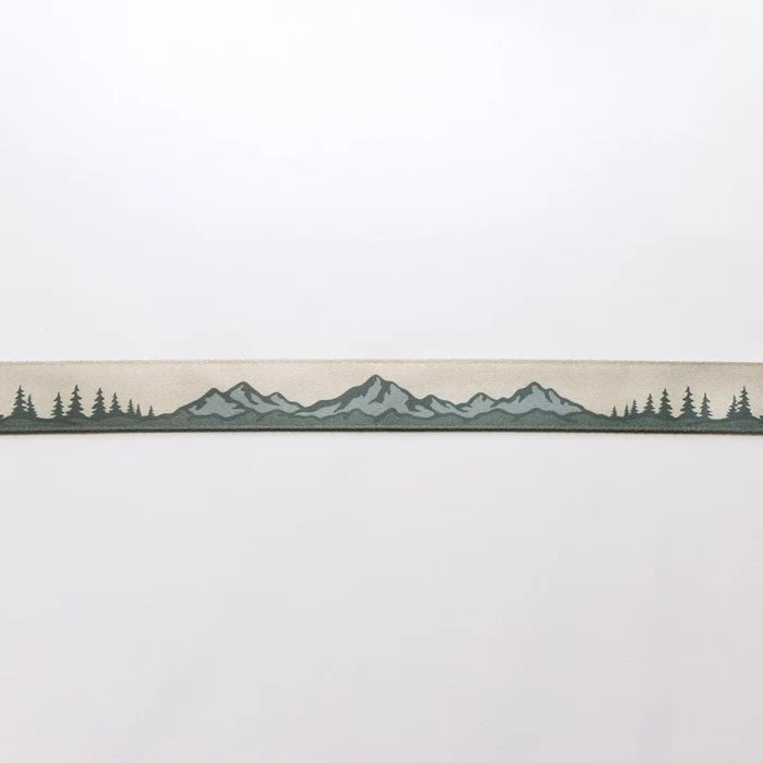 The Wildtree Landscape Camera Strap displays mountain and tree graphics on a light backdrop—nature-inspired accessory for photographers.