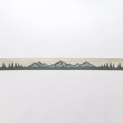 The Wildtree Landscape Camera Strap displays mountain and tree graphics on a light backdrop—nature-inspired accessory for photographers.