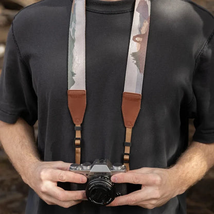 Photographer in black t-shirt holding camera featuring colorful Wildtree Parks In Colour Camera Strap, trendy accessory by Wildtree.