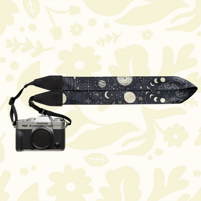 Forager Provisions LTD Wildtree camera strap with celestial sun and moon pattern attached to a silver mirrorless camera