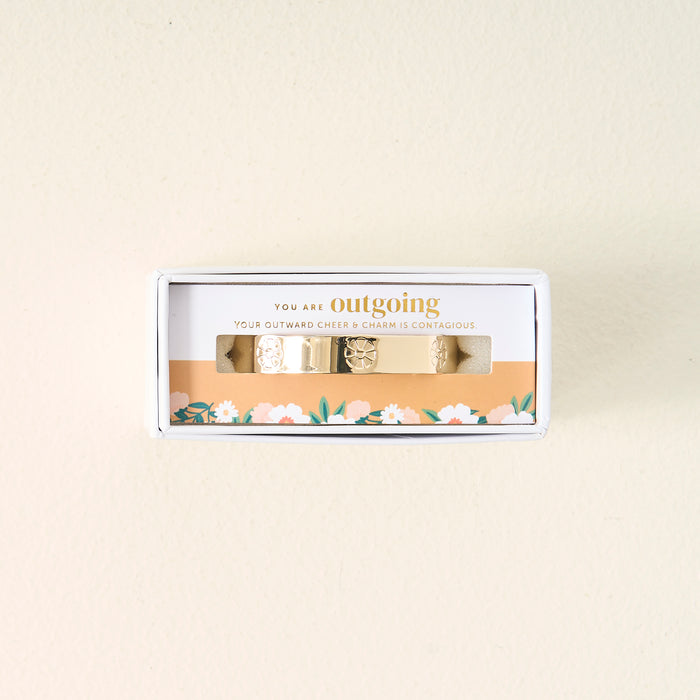 The Darling Effect’s You Are Outgoing Cuff Bracelet comes in a small box with a floral design and a card that reads, "You are outgoing. Your outward cheer & charm is contagious." A thoughtful gift for someone special.