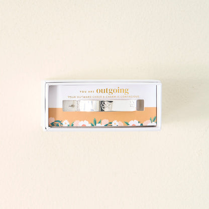 The Darling Effect’s You Are Outgoing Cuff Bracelet, featuring floral engravings, comes in a gift box that says “YOU ARE outgoing and YOUR OUTWARD CHEER & CHARM IS CONTAGIOUS”—a meaningful gift for someone special.